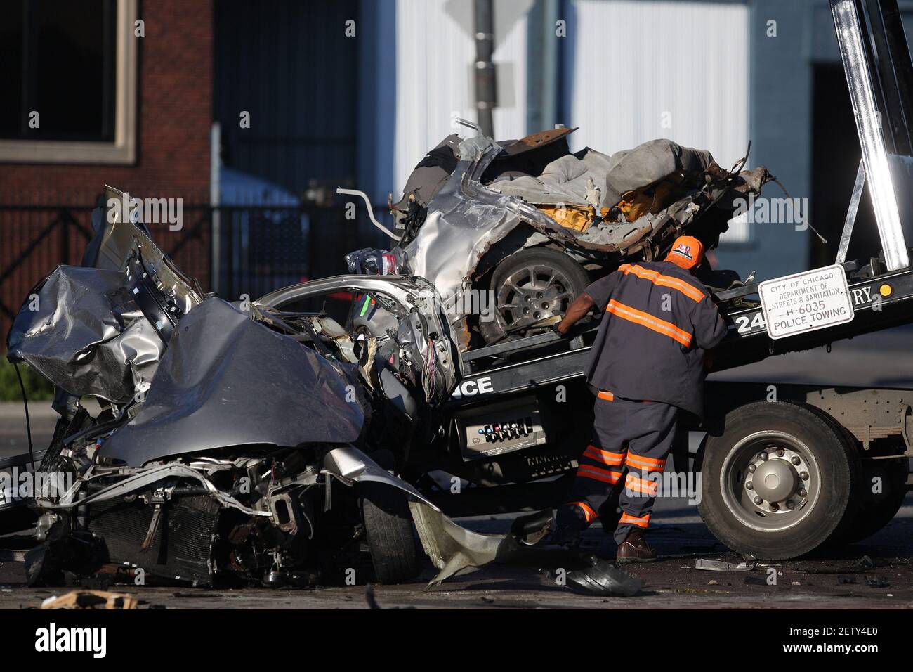 A wrecked car is extracted by a tow truck at the scene of a double