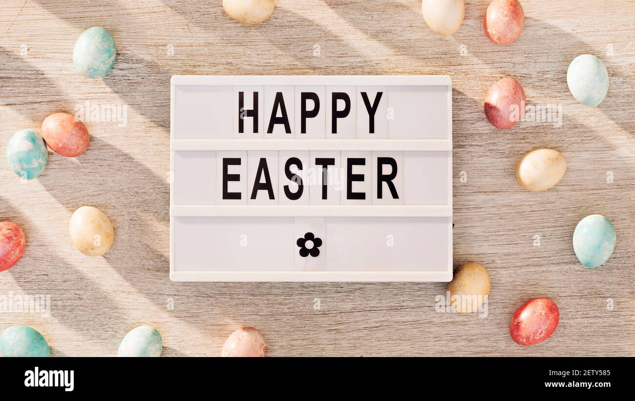 Easter eggs and cinema lightbox with holiday greeting Stock Photo