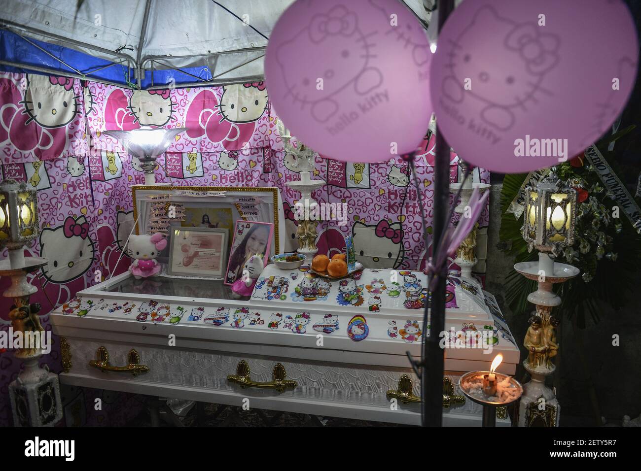 "Hello Kitty" decorations adorn the coffin of sixteen year old Nercy