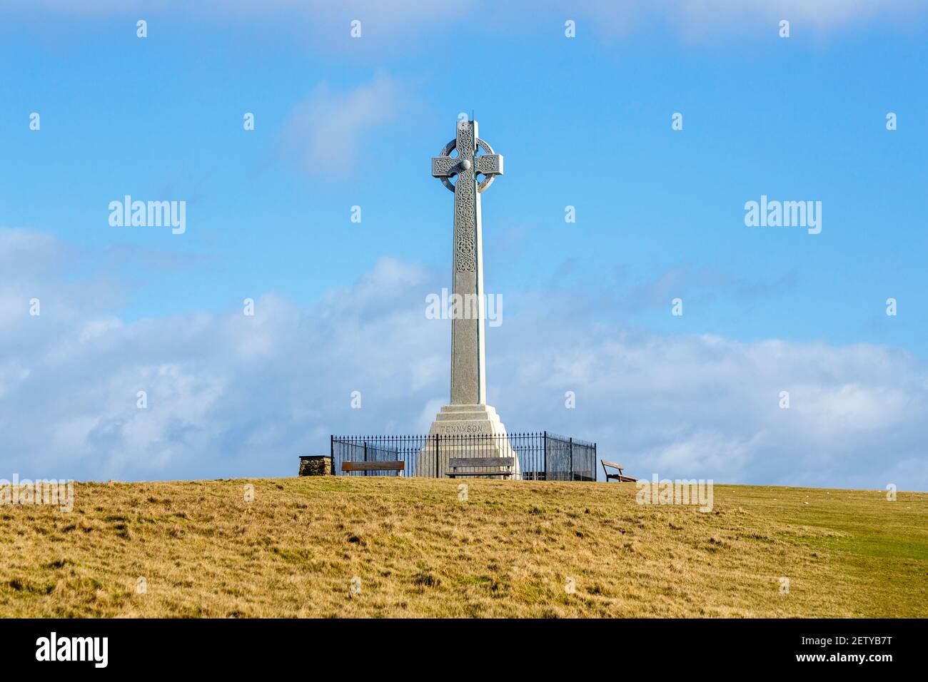 The cliff top Tennyson Memorial erected in 1897 on Tennyson Down in the Needles Country Park, Freshwater, Isle of Wight, southern Englandwith blue sky Stock Photo