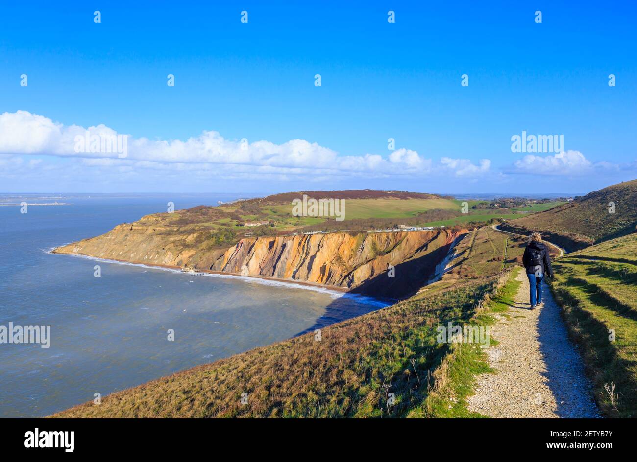 The multi-coloured Eocene sand cliffs of Alum Bay, Isle of Wight, from which sand layer tourist souvenirs are made and view across the Solent Stock Photo
