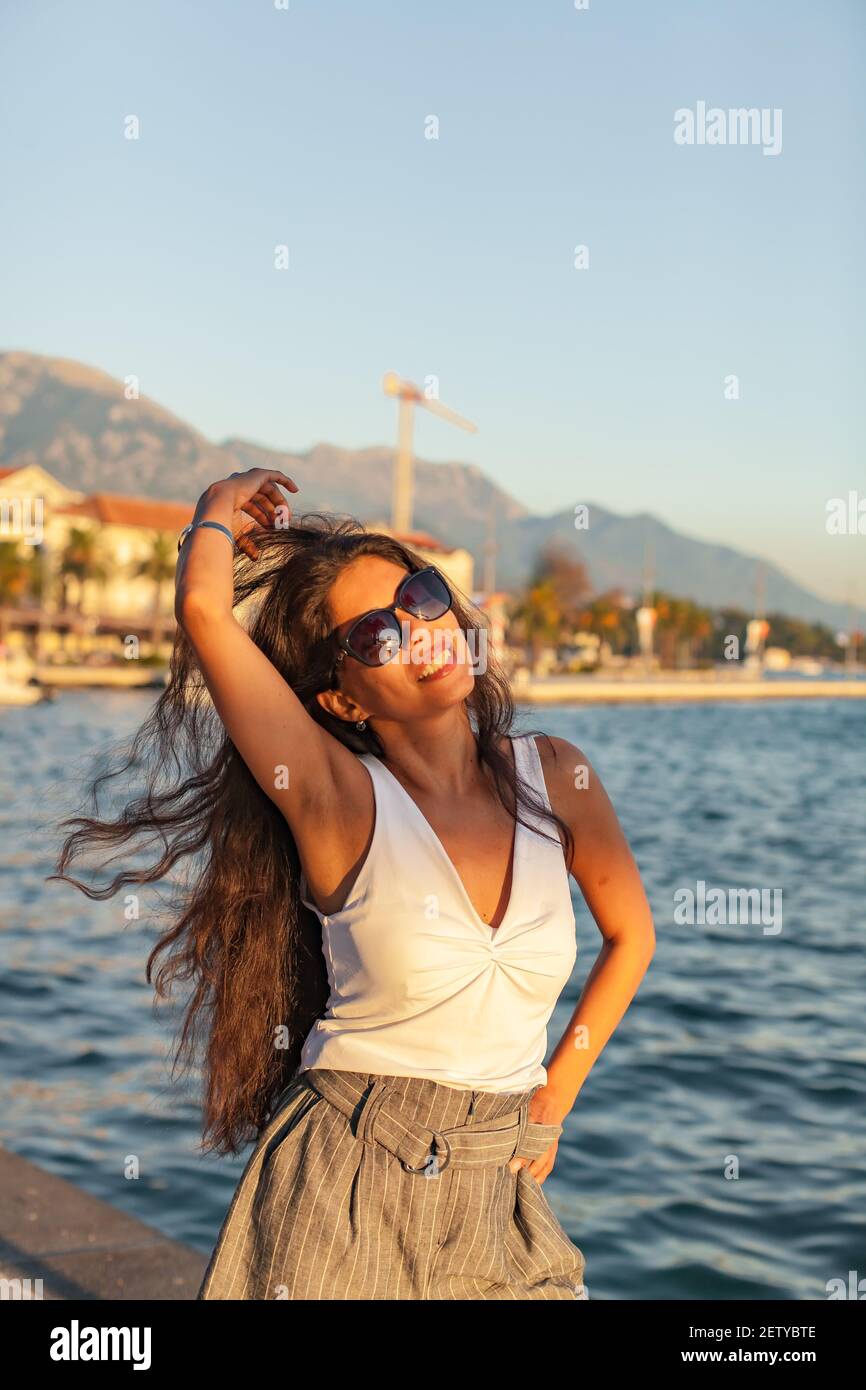 Young woman with long hair are happy, sunny day and sea. Vacation in Europe Stock Photo