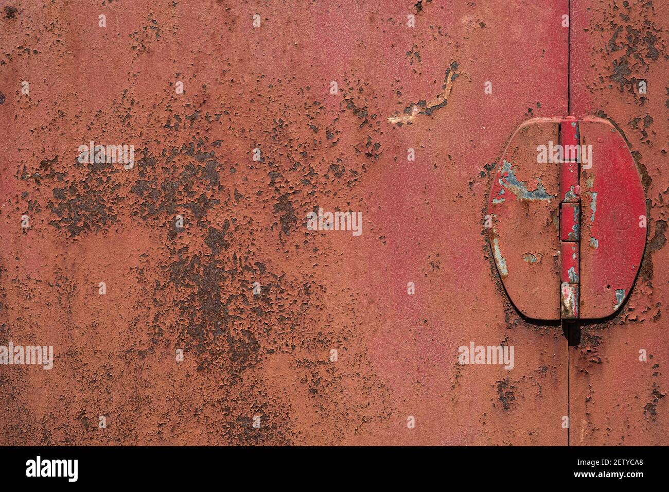 Old red iron door, rusted steel surface texture, rough peeling paint