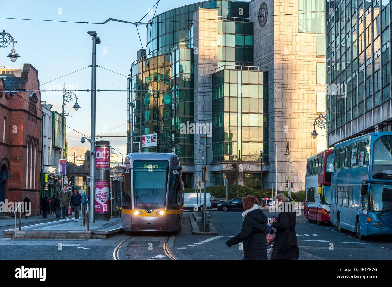 Early morning commuters and LUAS tram in financial district, Dublin, Ireland Stock Photo