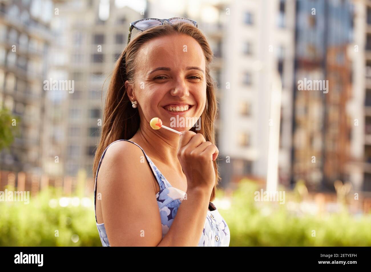 happy young woman with lollipop looking at camera Stock Photo
