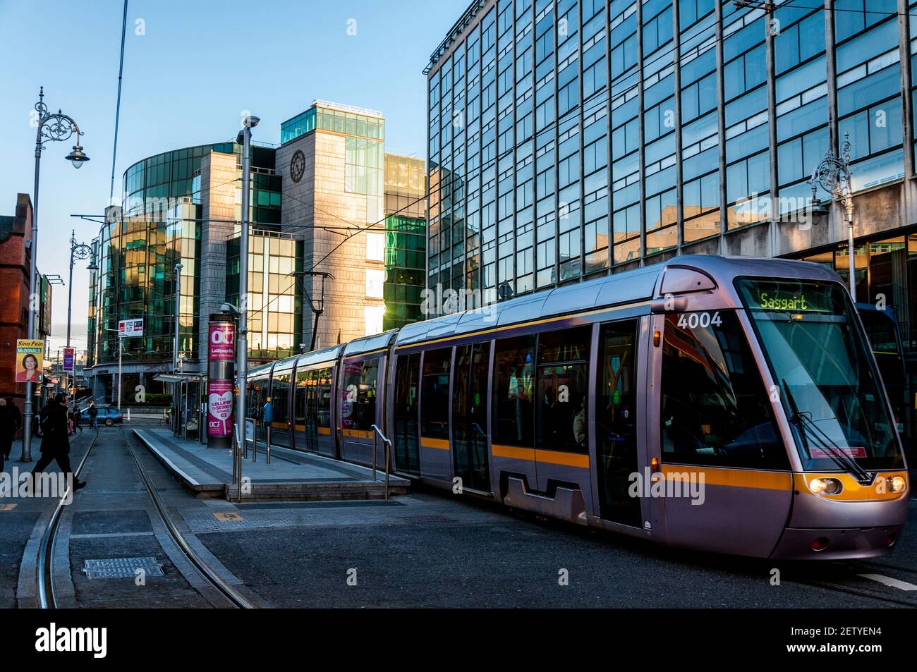Early morning commuters and LUAS tram in financial district, Dublin, Ireland Stock Photo