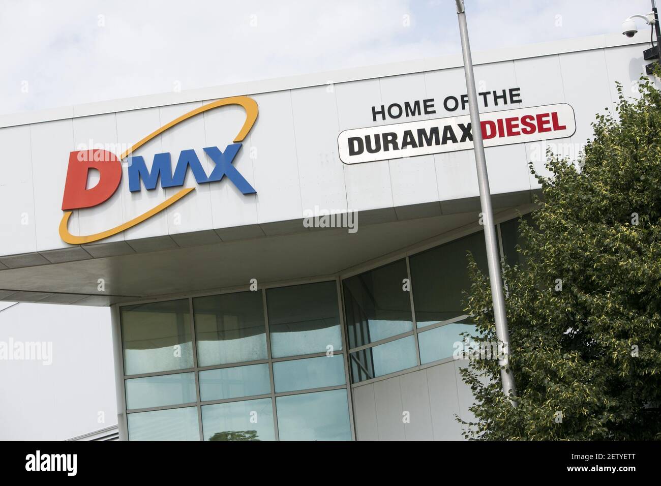 A logo sign outside of the headquarters of the Dmax engines factory in