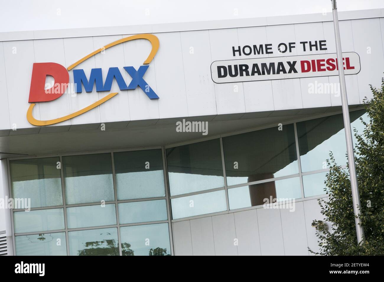 A logo sign outside of the headquarters of the Dmax engines factory in