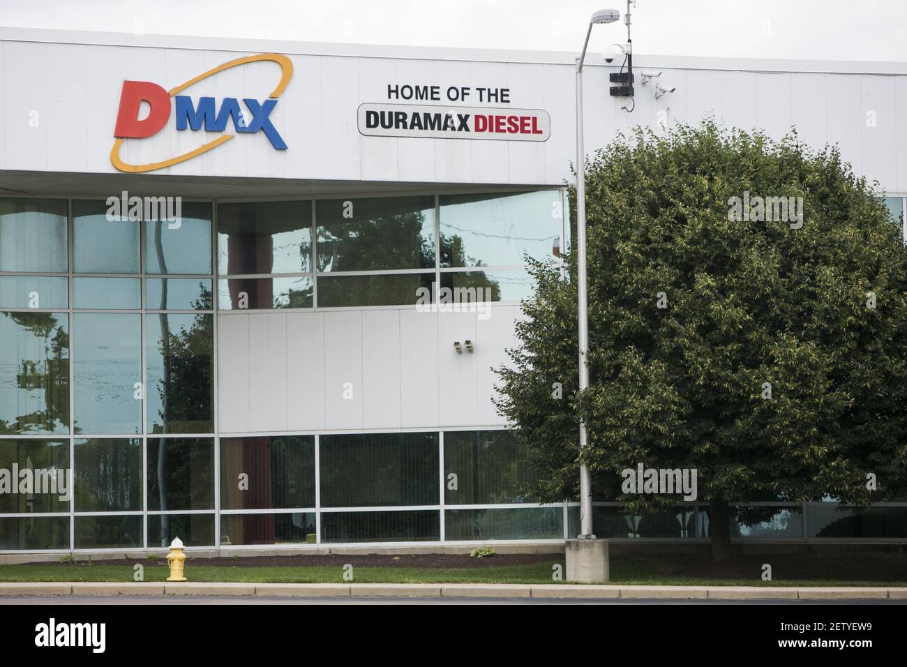 A logo sign outside of the headquarters of the Dmax engines factory in