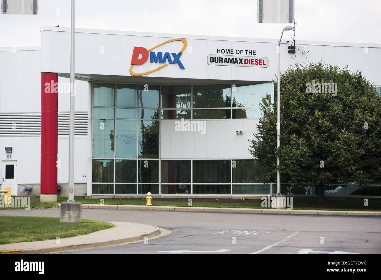 A logo sign outside of the headquarters of the Dmax engines factory in