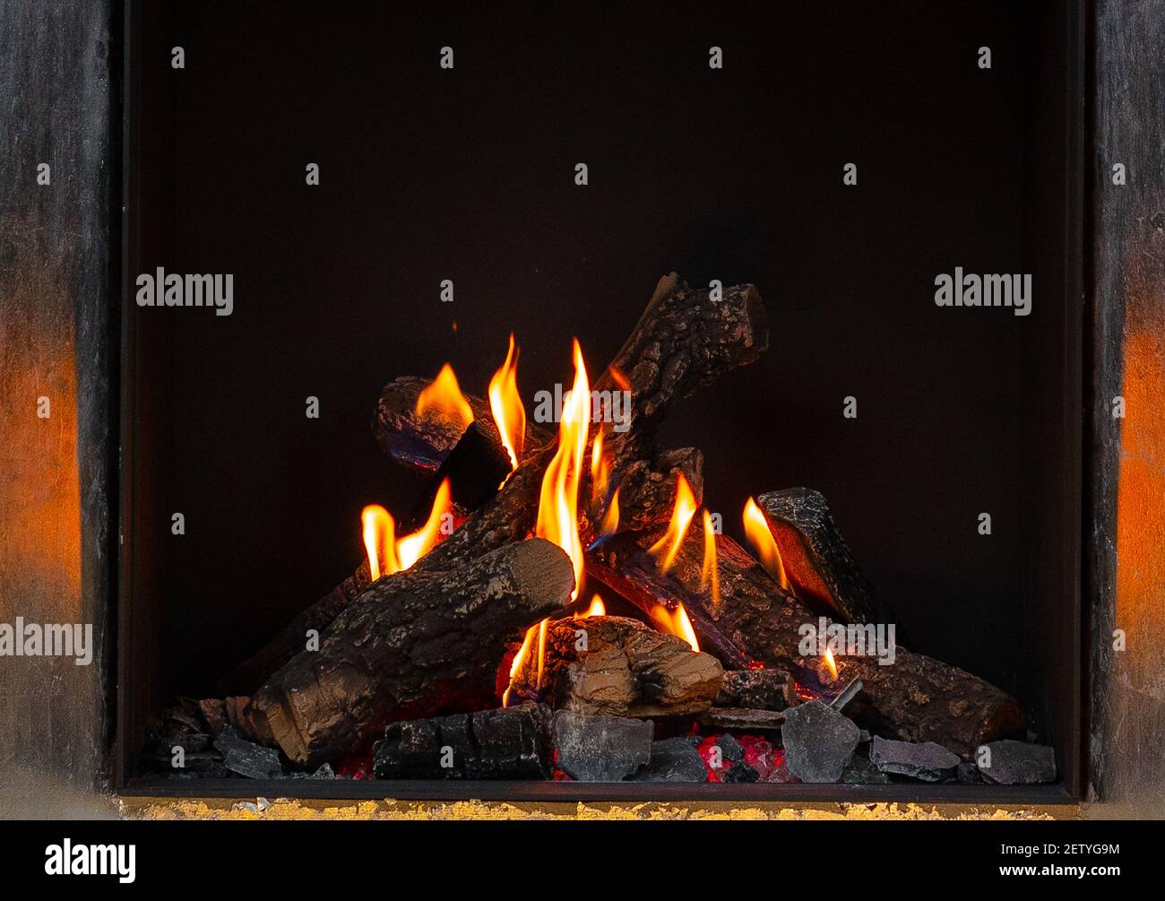 Wood logs burning in fireplace close up Stock Photo - Alamy