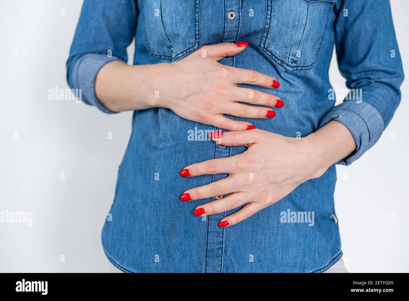 Young woman suffering from flank pain on white background Stock Photo