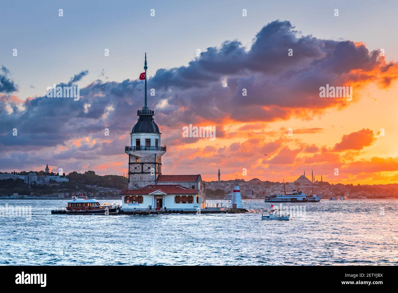 Istanbul, Turkey. Sunset over Bosphorus with famous Maiden's Tower (Kiz Kulesi) symbol of Istanbul, Turkey. Scenic travel background. Stock Photo