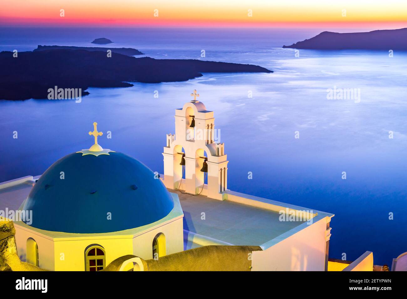 Santorini, Greece. Firostefani twilight with old greek church and caldera at Aegean Sea. Stock Photo