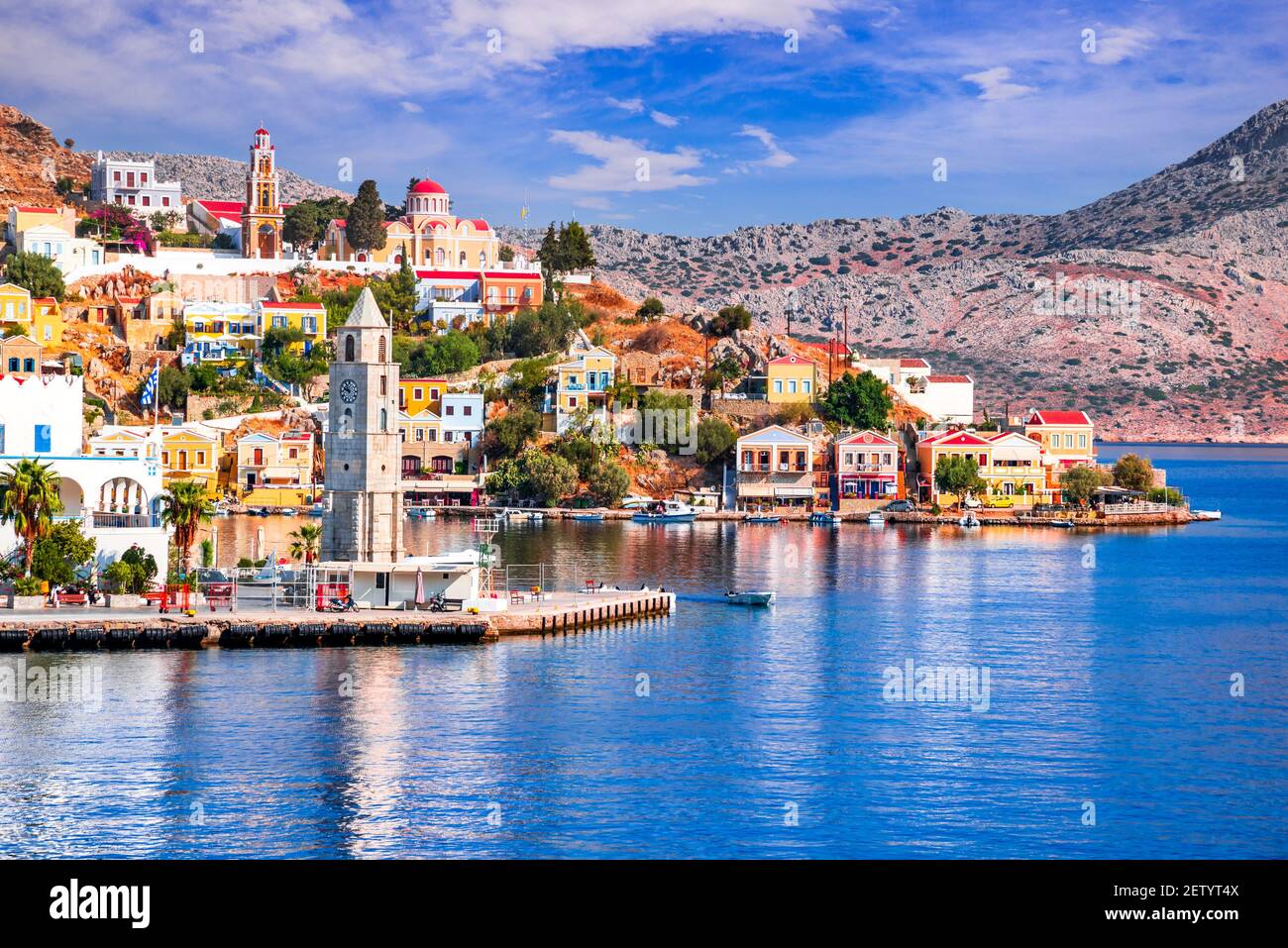 Symi Island, Greece. Greece islands holidays vacation travel tours from Rhodos island in Aegean Sea. Colorful neoclassical houses in bay of Symi. Stock Photo