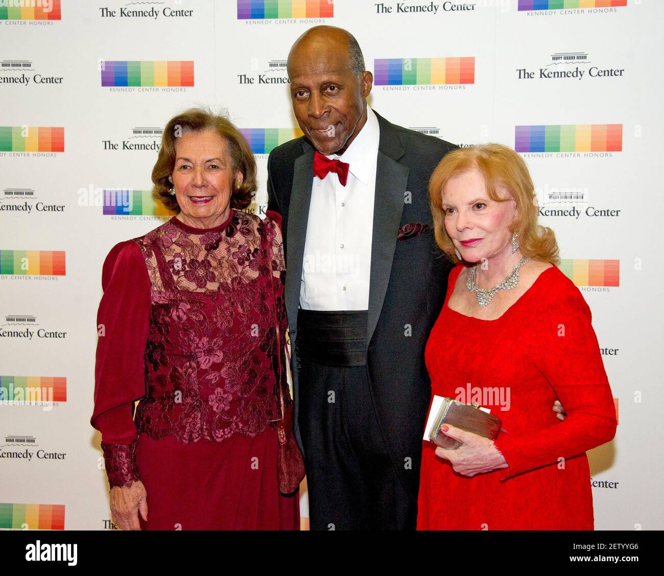 Ann Jordan, left, Vernon Jordan, center, and Buffy Cafritz, right, arrive for the formal Artist's Dinner honoring the recipients of the 39th Annual Kennedy Center Honors hosted by United States Secretary of State John F. Kerry at the U.S. Department of State in Washington, DC on Saturday, December 3, 2016. The 2016 honorees are: Argentine pianist Martha Argerich; rock band the Eagles; screen and stage actor Al Pacino; gospel and blues singer Mavis Staples; and musician James Taylor.Credit: Ron Sachs/Pool via CNP | usage worldwide Stock Photo