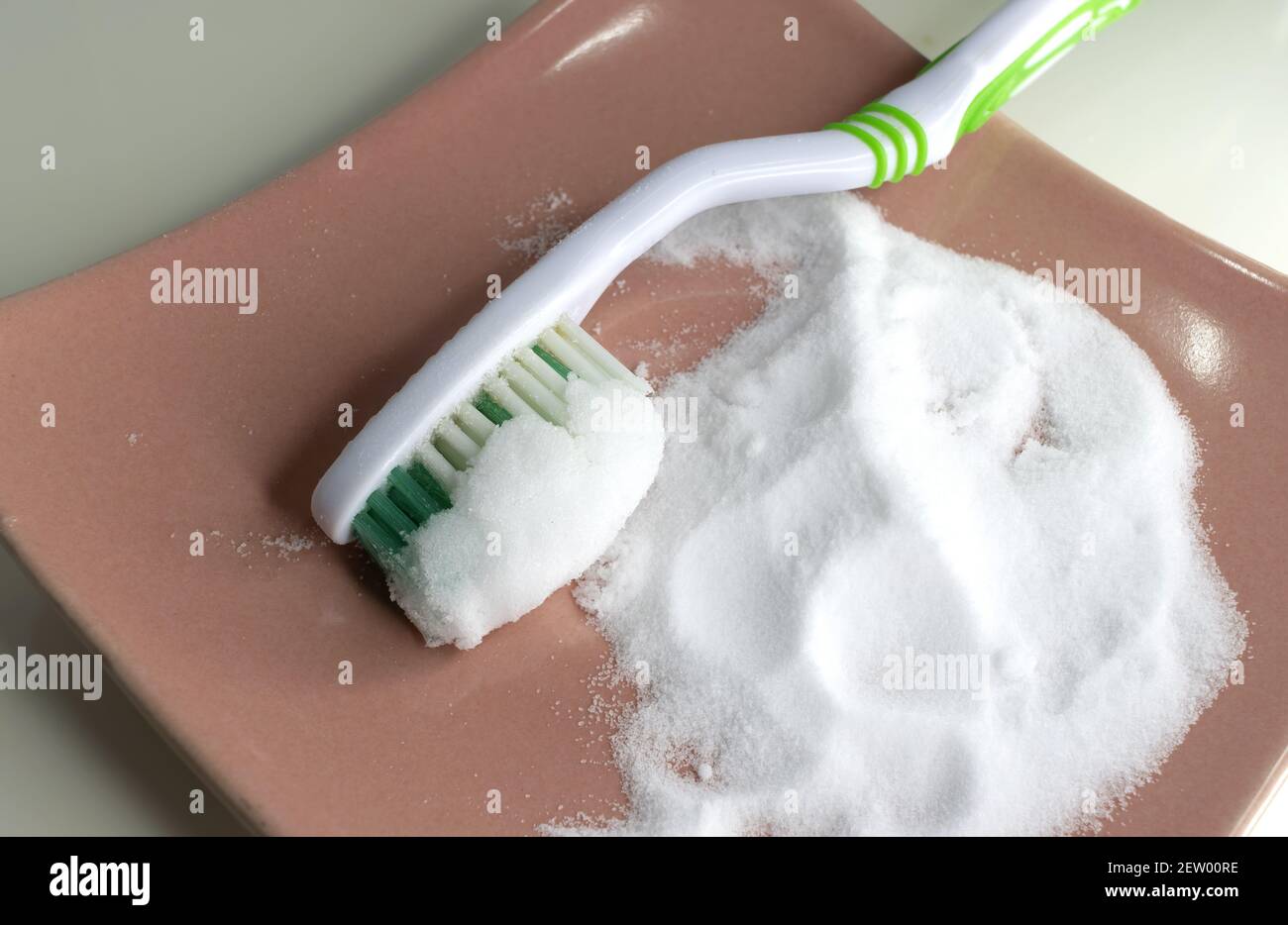 Cleaning teeth with toothbrush and baking sod Stock Photo