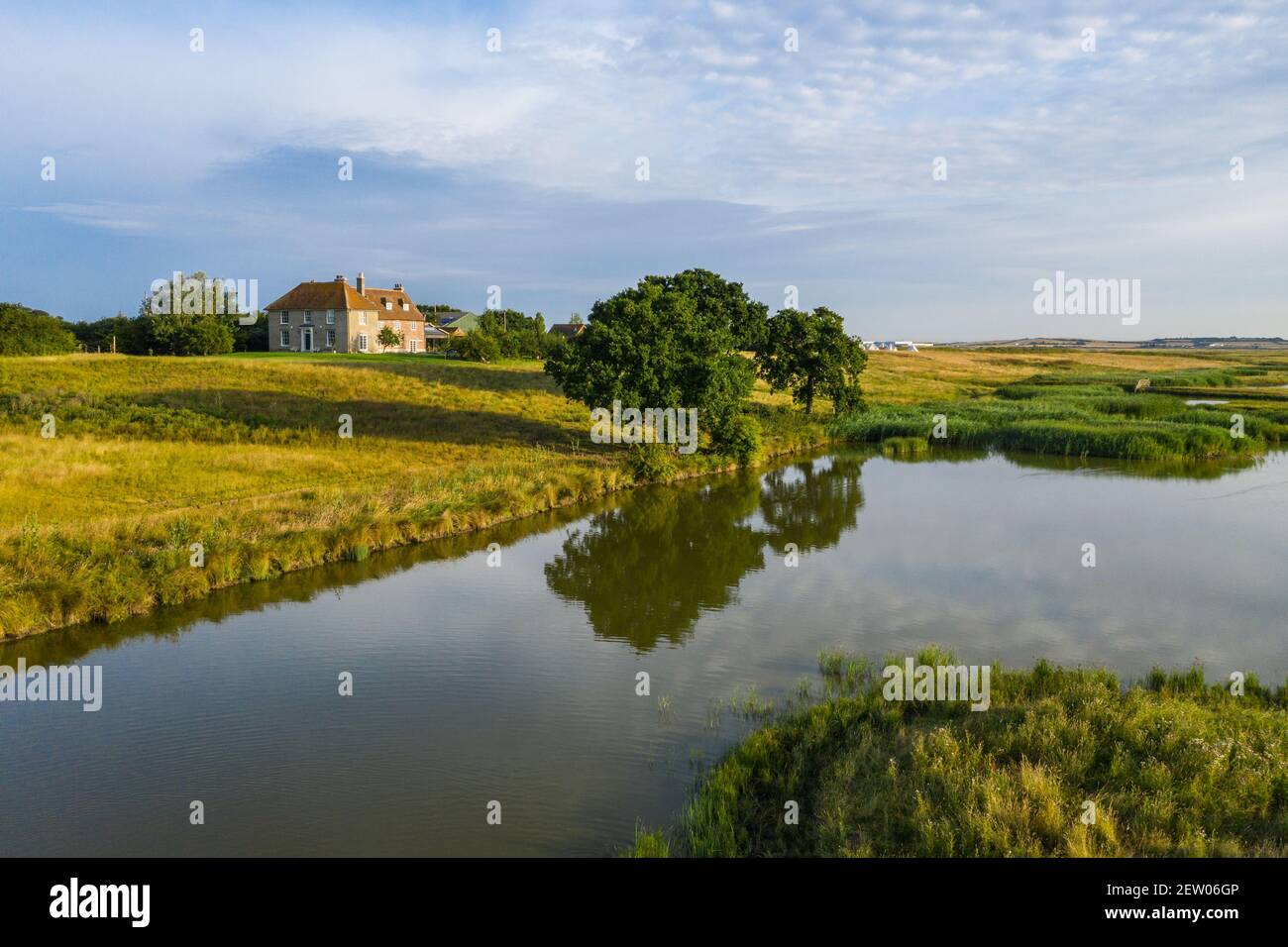 Off-grid farmhouse on riverbank in Elmley nature reserve, Sheppey. Stock Photo