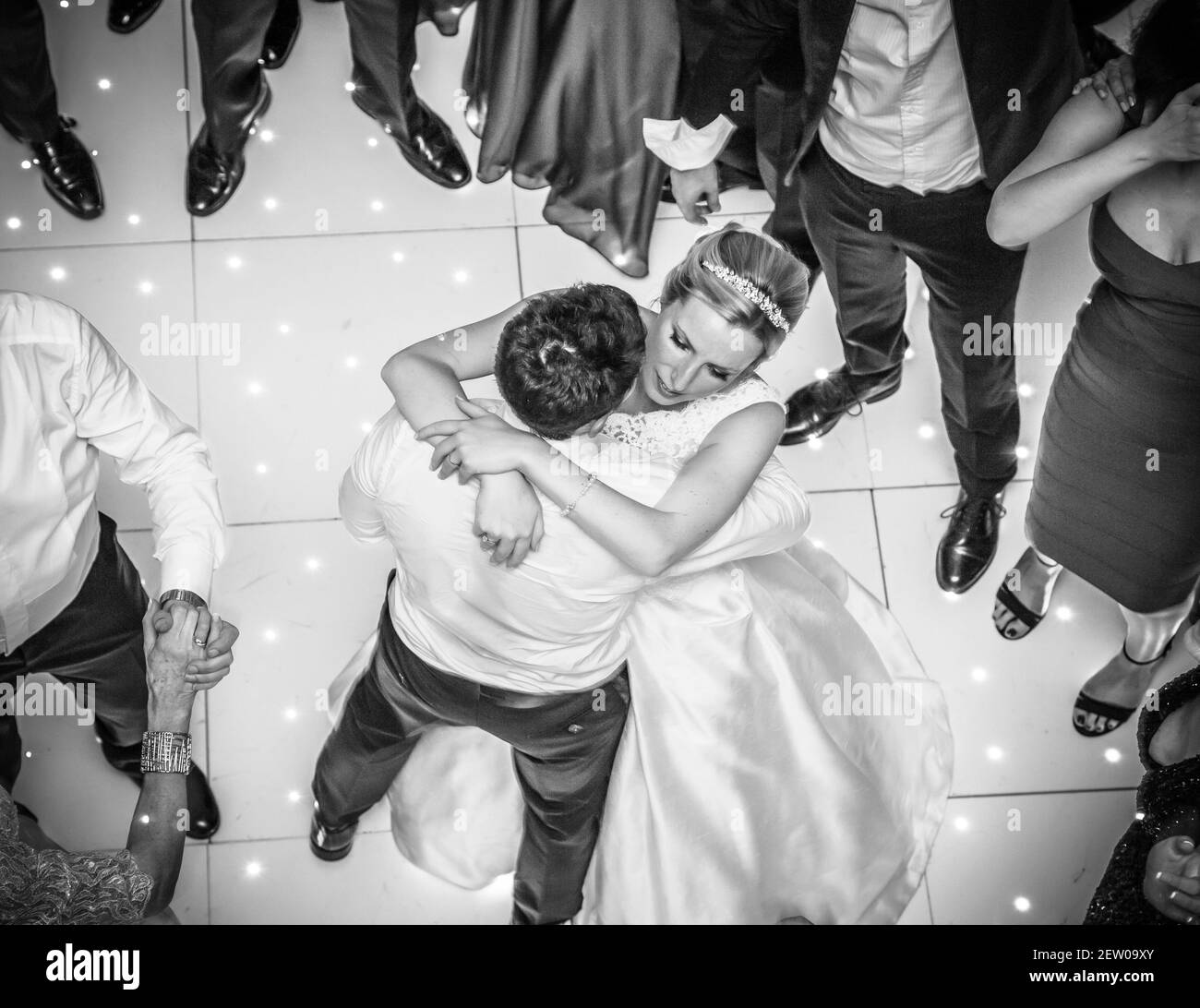 Bride and Bridegroom on the dance floor with their guests. Shot from over the top view. Stock Photo