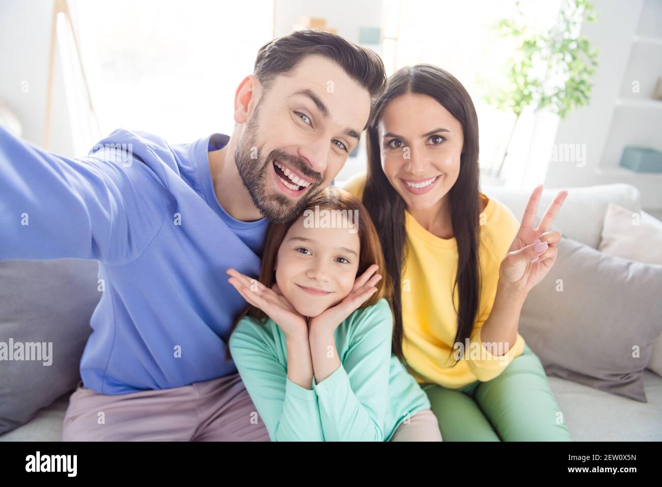 Photo of cheerful young family mom dad daughter happy positive smile ...
