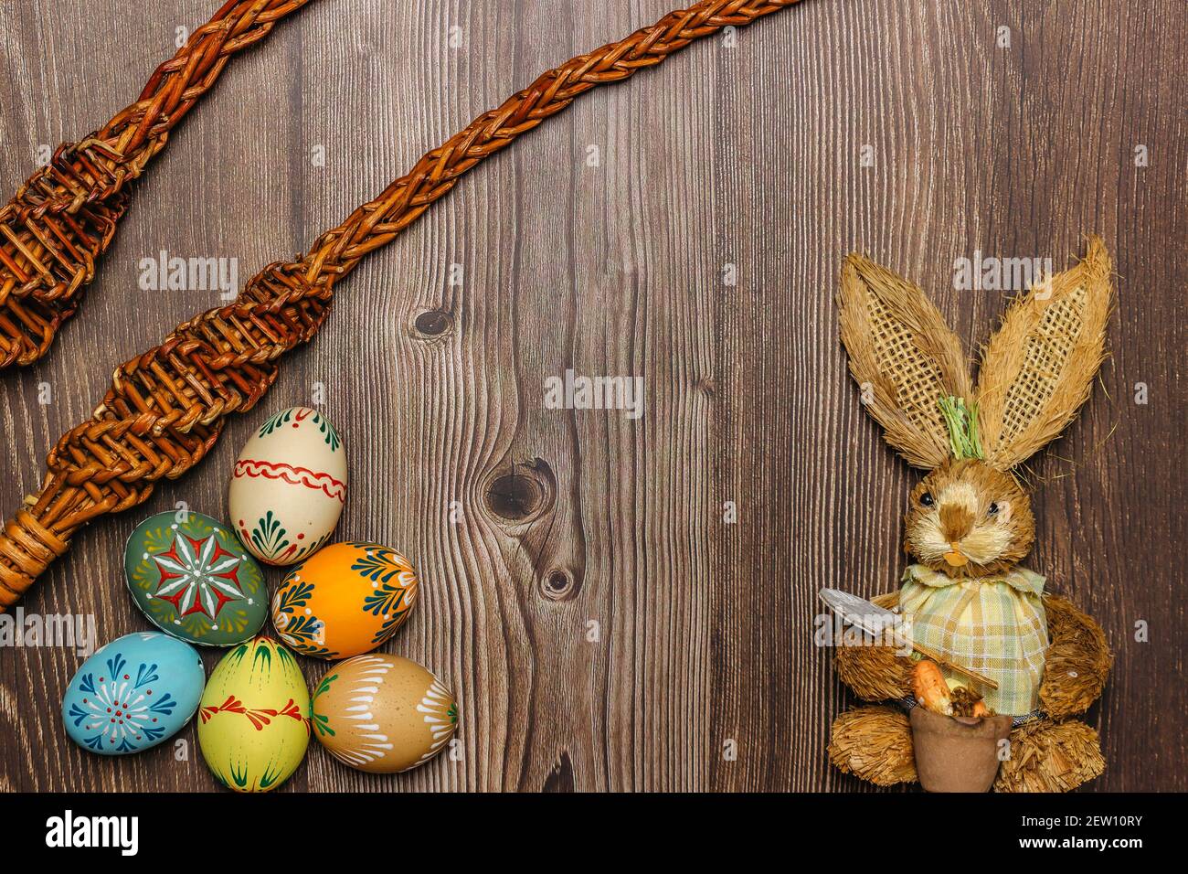 Colorful Easter Eggs,bunny,willow branches banner.Above view with copy space.Happy Easter decoration background,colorful hand painted decorated eggs. Stock Photo