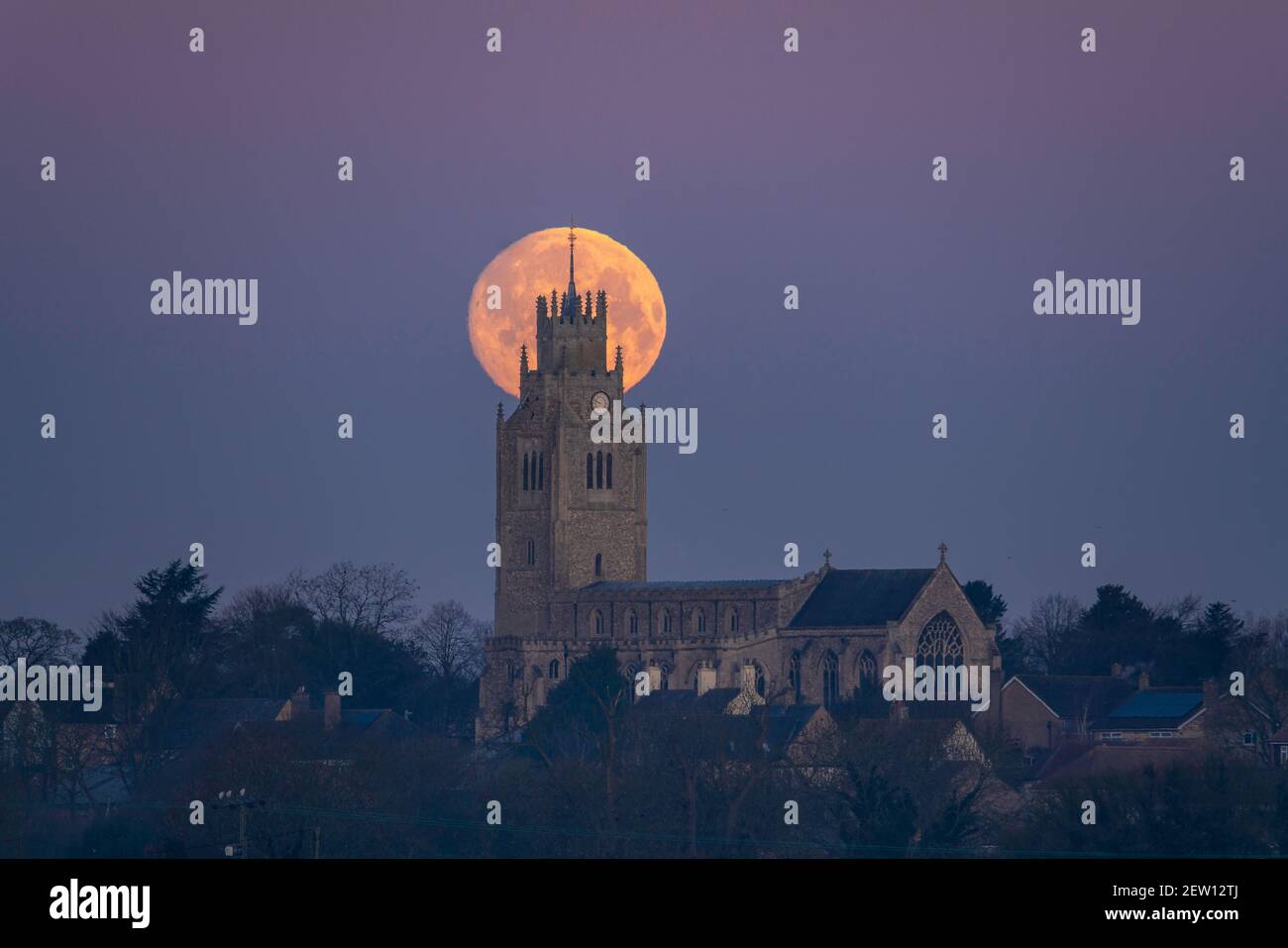 Moonset behind St Andrew's Church, Sutton-in-the-Isle, Cambridgeshire, UK Stock Photo