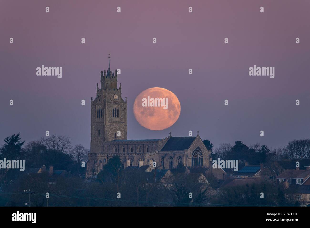 Moonset behind St Andrew's Church, Sutton-in-the-Isle, Cambridgeshire, UK Stock Photo