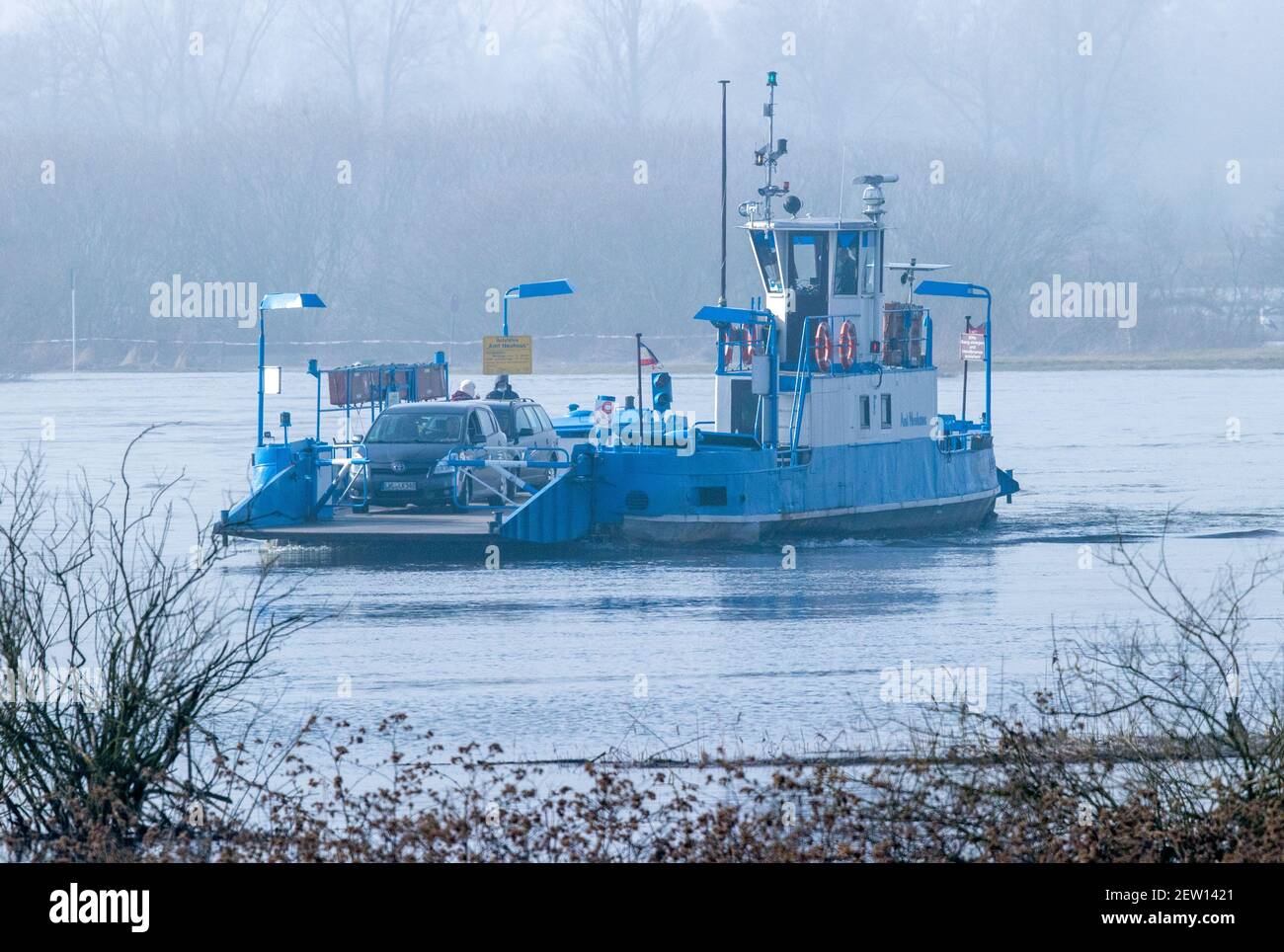Bleckede, Germany. 02nd Mar, 2021. Despite high water, the Elbe ferry 'Amt Neuhaus' shuttles on the Elbe between Bleckede and Neu Bleckede and transports vehicles and pedestrians. Even when the Elbe has overflowed its banks, the ferries can still travel between the west and east banks on the former inner-German border river without any major problems. Credit: Jens Büttner/dpa-Zentralbild/dpa/Alamy Live News Stock Photo
