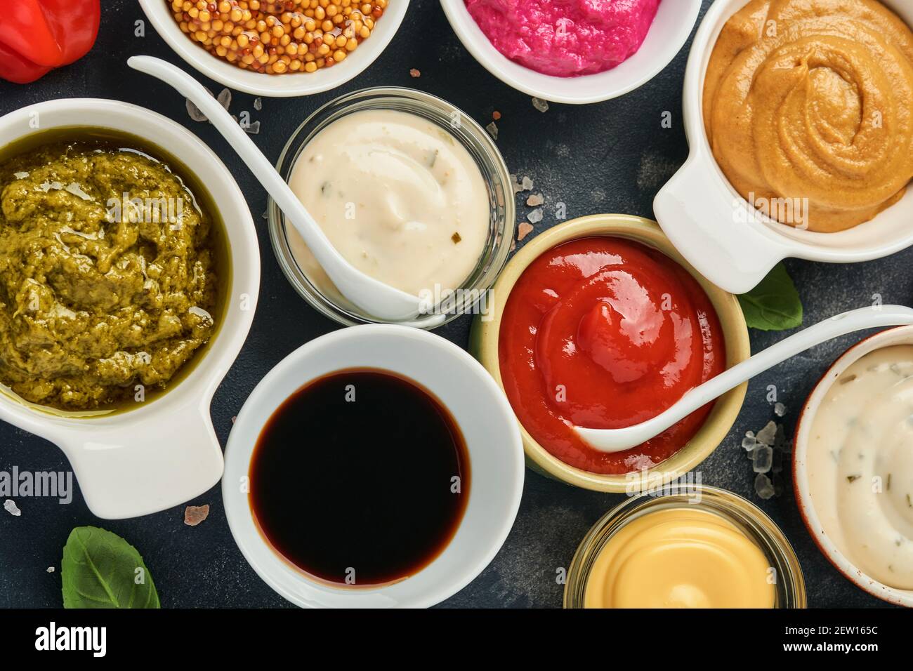 Set of sauces in bowls - ketchup, mayonnaise, mustard, soy sauce, bbq sauce,  pesto, chimichurri, mustard grains on dark stone background. Top view cop  Stock Photo - Alamy