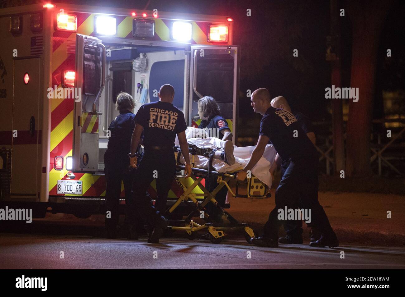 Paramedics load a shooting victim into an ambulance in the 800 block of ...