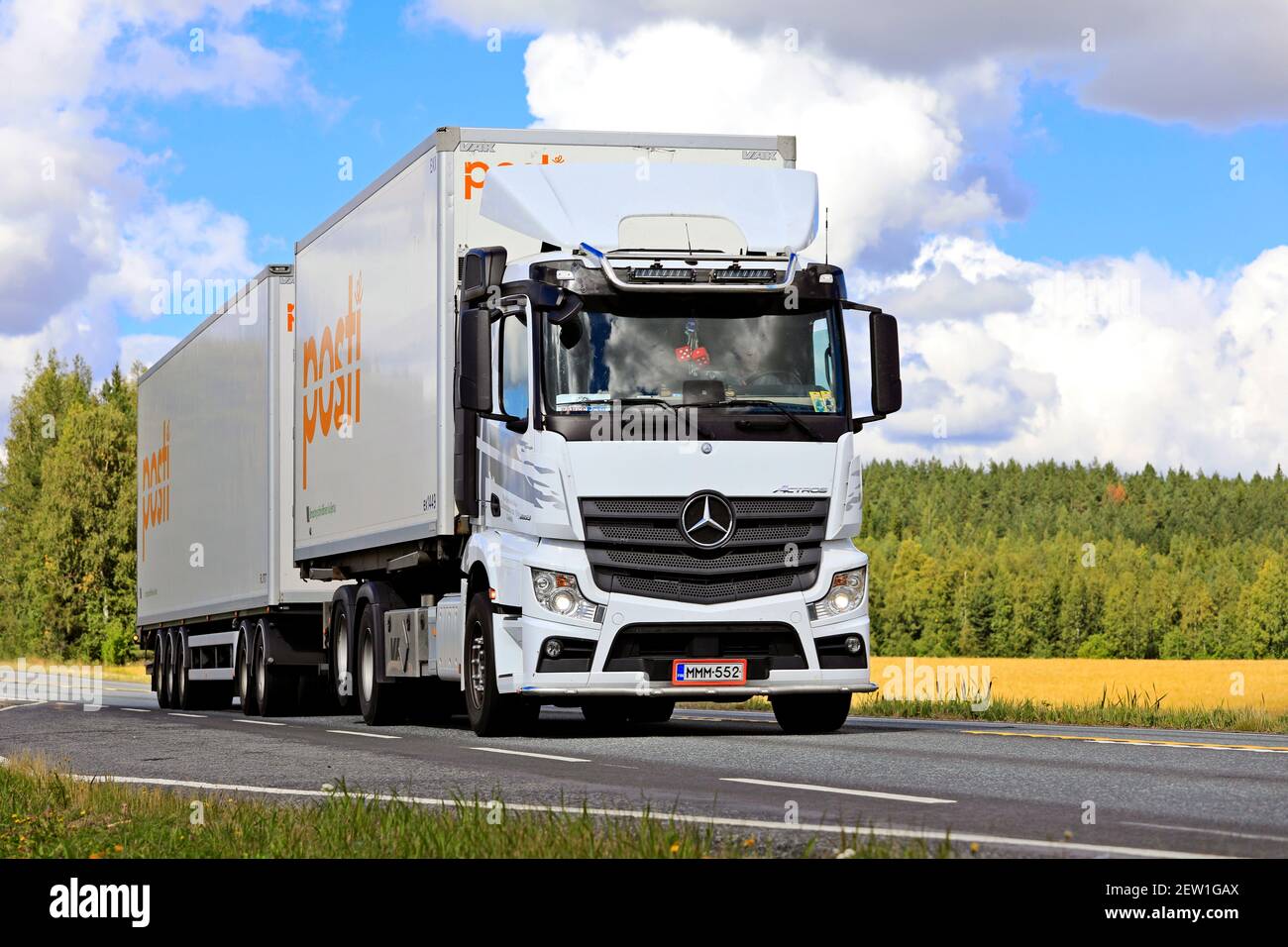 White Mercedes-Benz Actros truck for the deliveries of Finnish Post, Posti Kuljetus Oy pulls trailer on highway 2  Jokioinen, Finland. August 28, 2020 Stock Photo