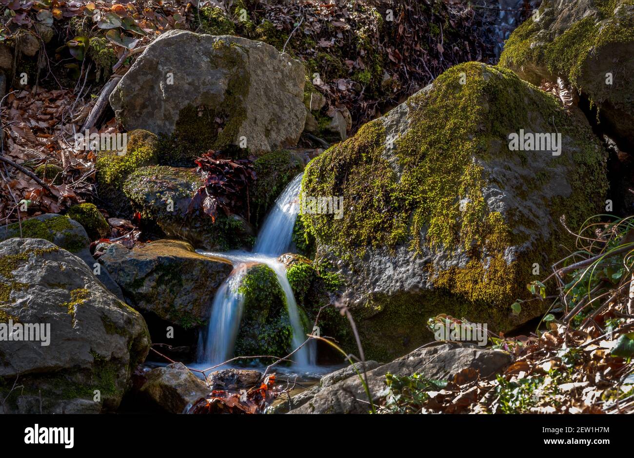 Small Spring Flowing From Rocks Spring river flowing between rocks hi-res stock photography and images ...