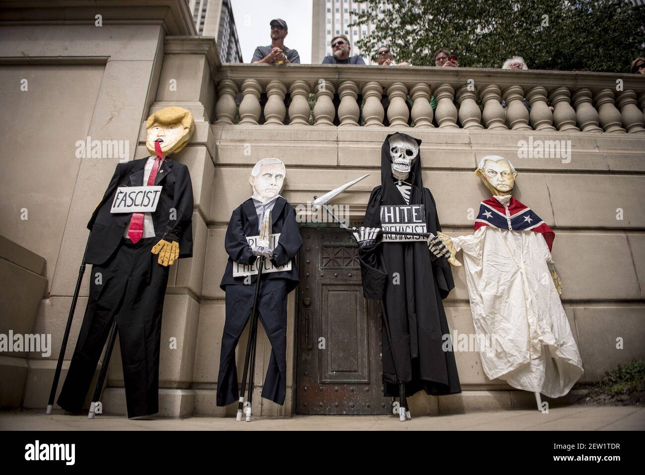 Puppets depicting U.S. President Donald Trump, Vice President Mike Pence, and U.S. Attorney General Jeff Sessions rest against a wall during a rally in downtown Chicago, IL one day after white nationalists attacked counter-protestors in Charlottesville, VA. Sunday August 13, 2017. Photographer: Christopher Dilts/Sipa USA *** Please Use Credit from Credit Field *** Stock Photo