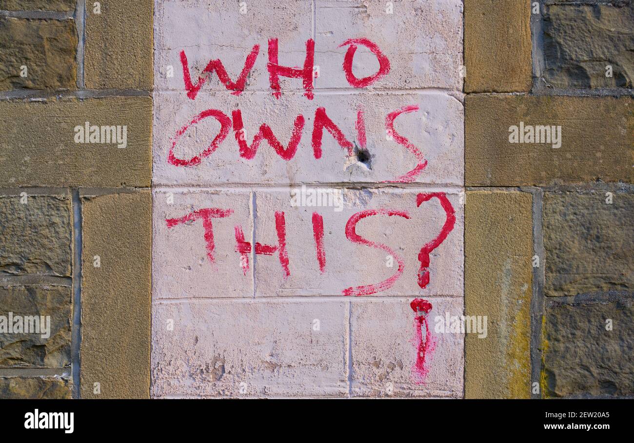 who owns what exactly? what is the question? who owns the word, THIS, or who owns the building or who owns the writing if it is to be considered art? Stock Photo