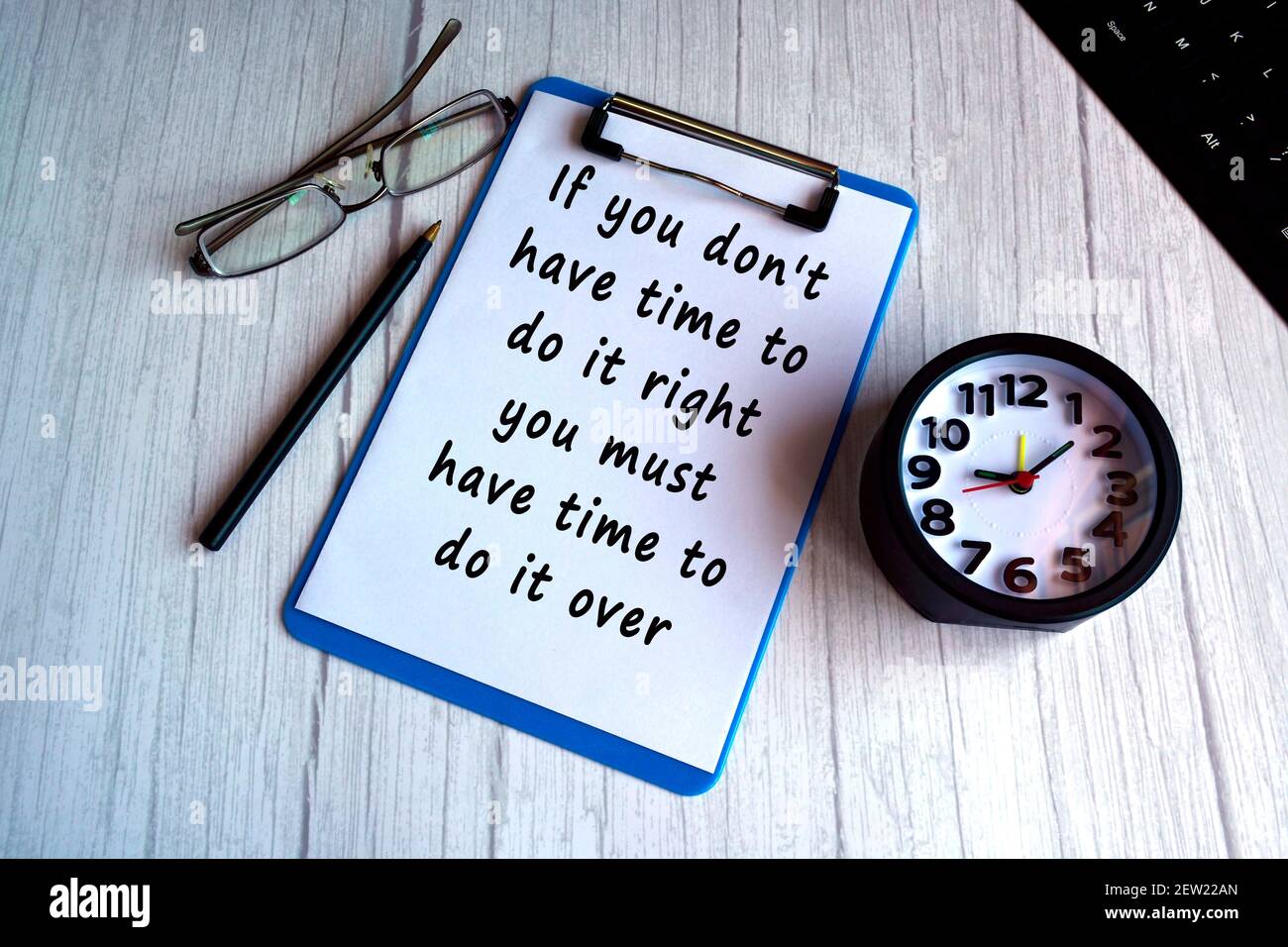 Motivational quote on blue clip board with alarm clock on wooden desk Stock  Photo - Alamy