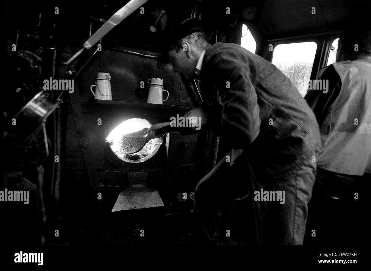 Steam Train May 1999The engine fireman Peter Ftizwater stikes the fire on the 13.58 Watford Abersham which celebrates ten years of steam on the line Stock Photo
