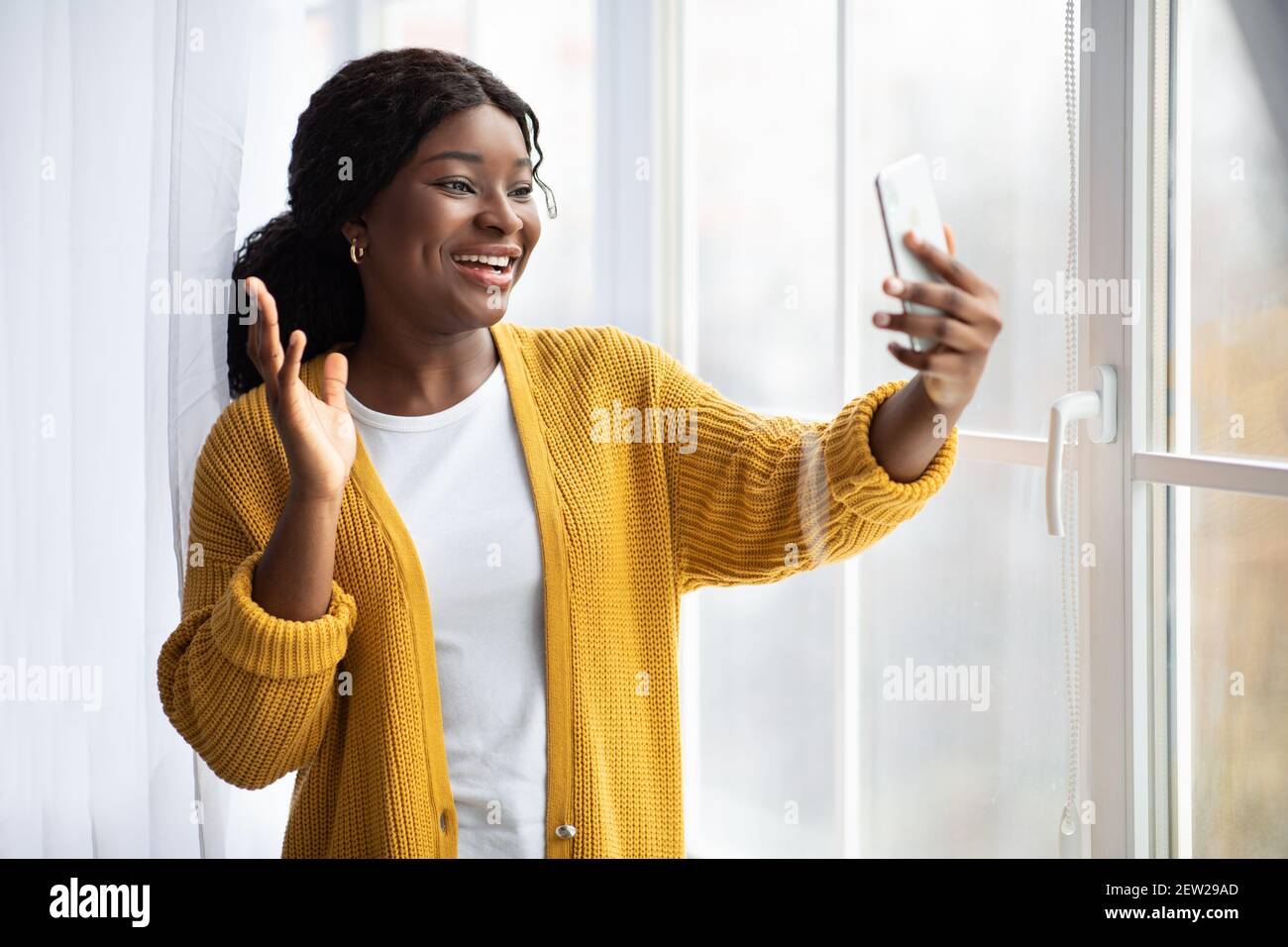 Positive black woman having video call on phone Stock Photo - Alamy