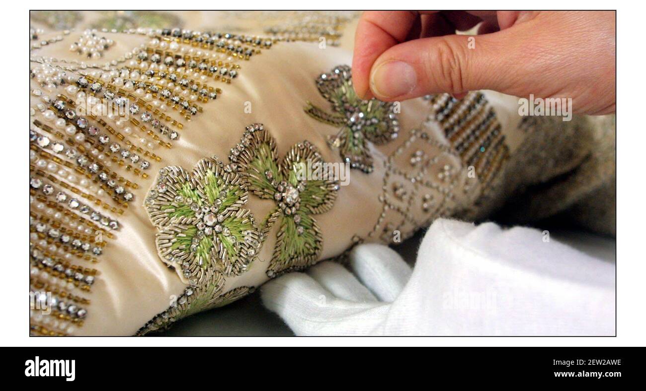 The 50th anniversary of the Coronation of Queen Elizabeth ll will be celebrated at this year's Summer Opening of Buckingham Palace State Rooms with the display of Her Majesty's magnificent Coronation Dress, seen being prepared by Janet Wood, senior textile conservator at Hampton Court Palace. An extra Shamrock (four leaf clover) added by sir Norman Hartwell the designer of the dress......for Good Luck.pic David Sandison 30/5/2003 Stock Photo