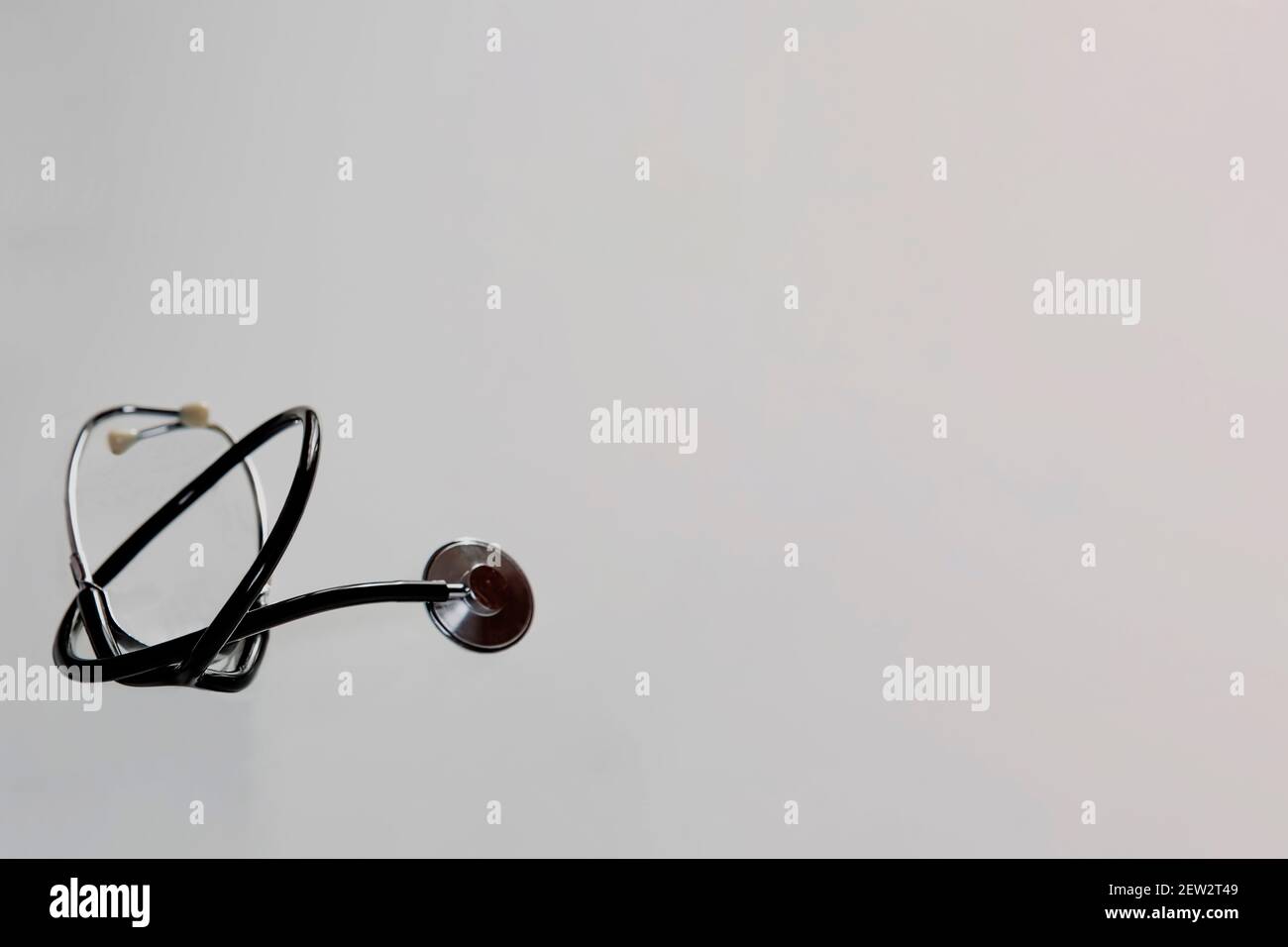 The stethoscope alone lies on a light background.  Stock Photo