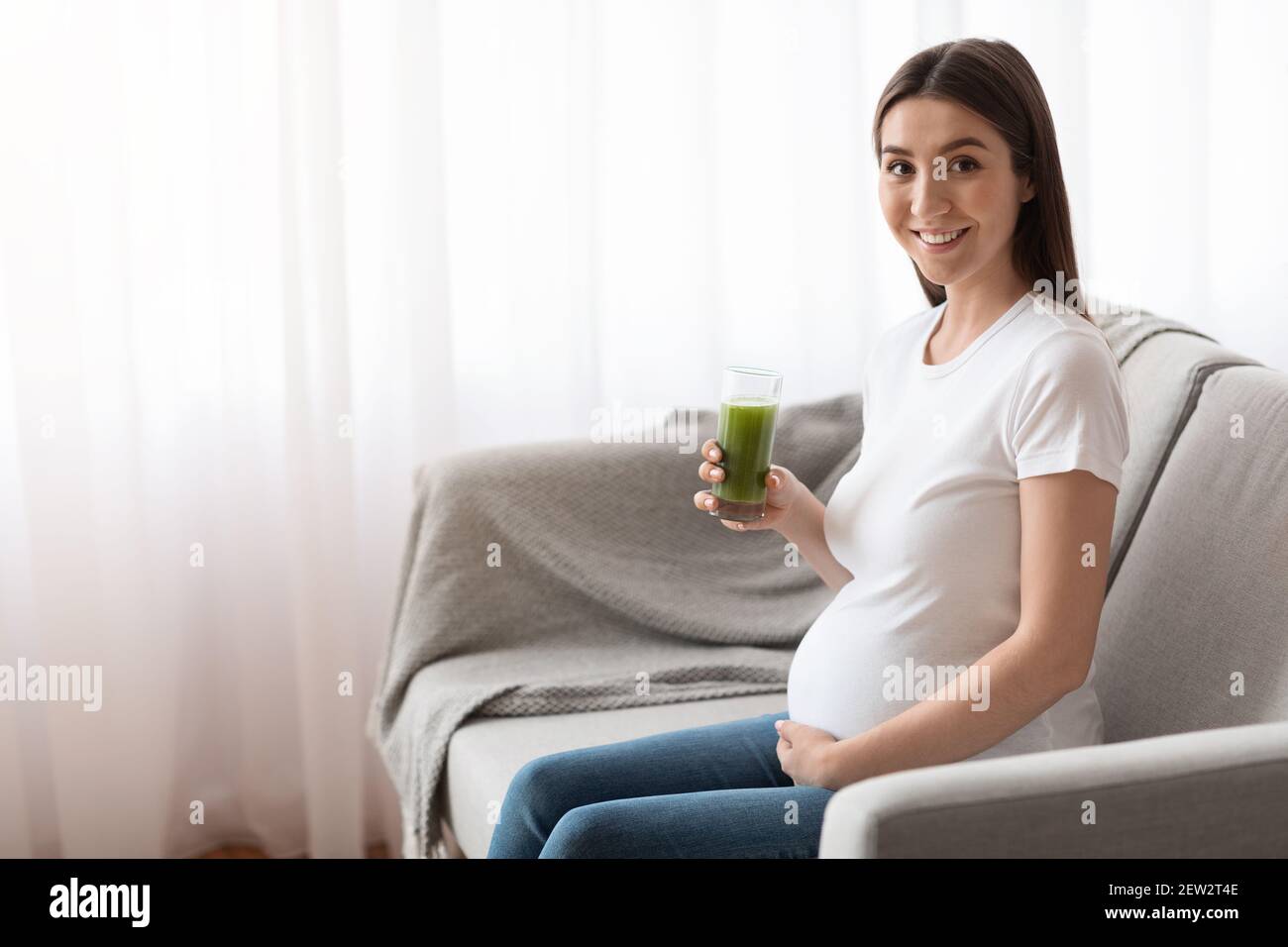 Vitamins During Pregnancy. Young Pregnant Woman Drinking Green Smoothie
