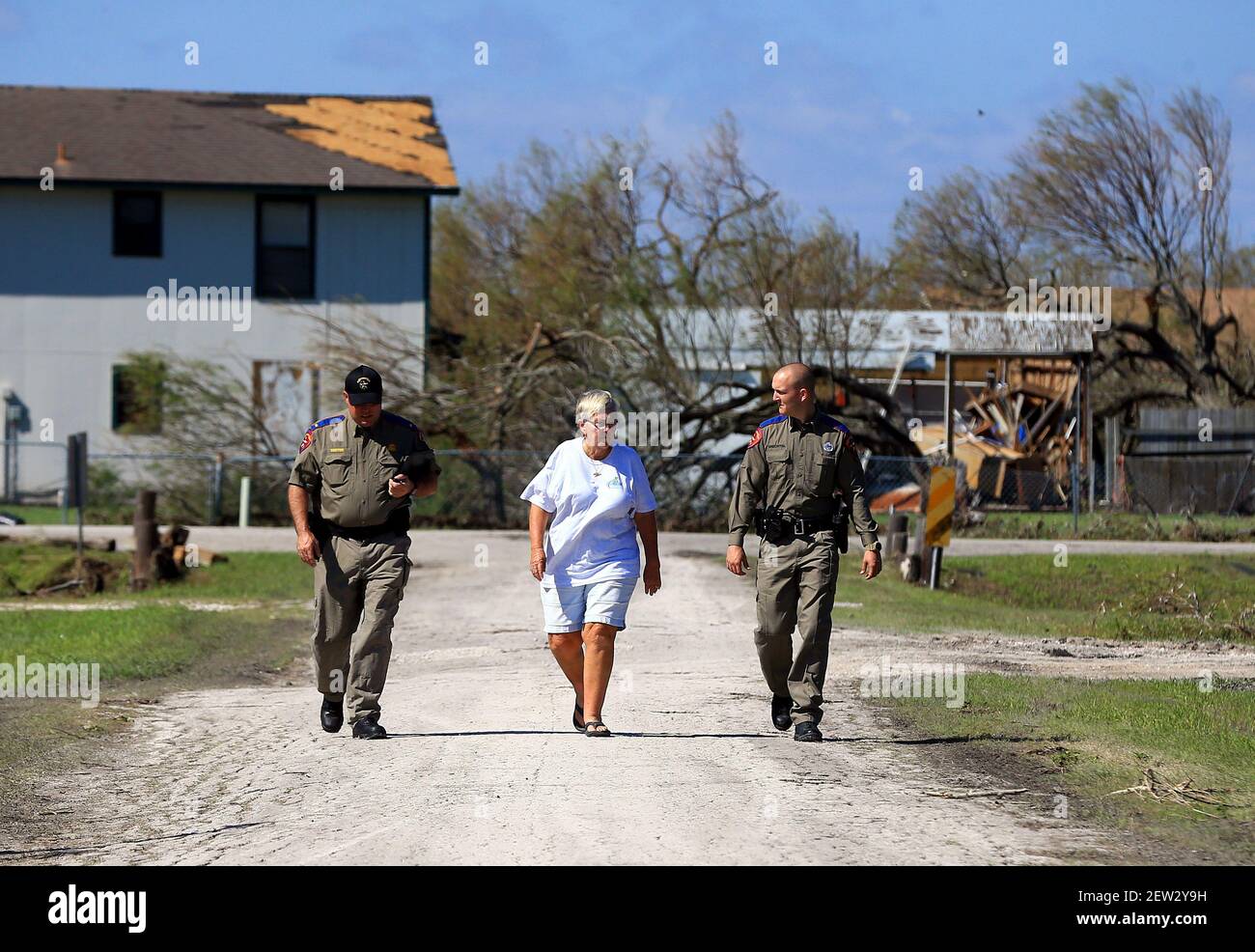 Bayside, Texas, Mayor Sharon Scott talks to Texas State Troopers as she walks around the town