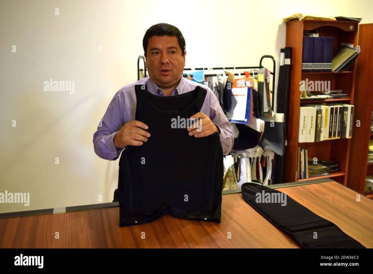Miguel Caballero, the founder of his eponymous bullet-proof clothing line,  shows off his patented bulletproof T-shirt, which recently won an  international design award. His company is starting to sell its products in