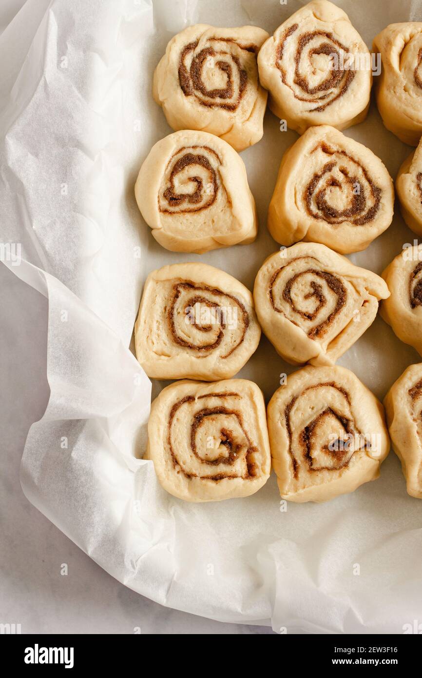 Baking dish filled with 12 slices of raw cinnamon rolls dough ready to be baked. Stock Photo