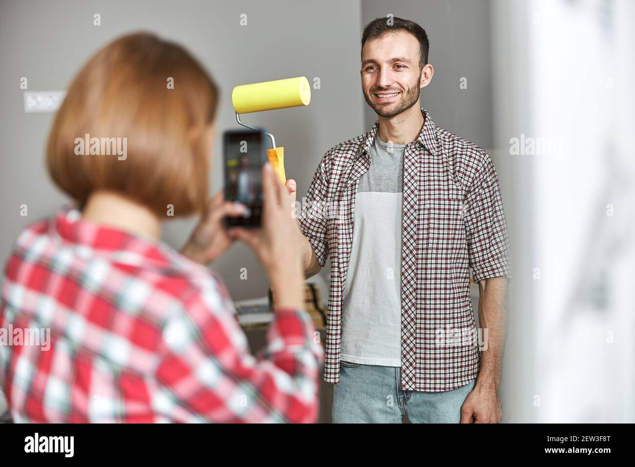 Joyous worker posing for the smartphone camera in the workplace Stock Photo