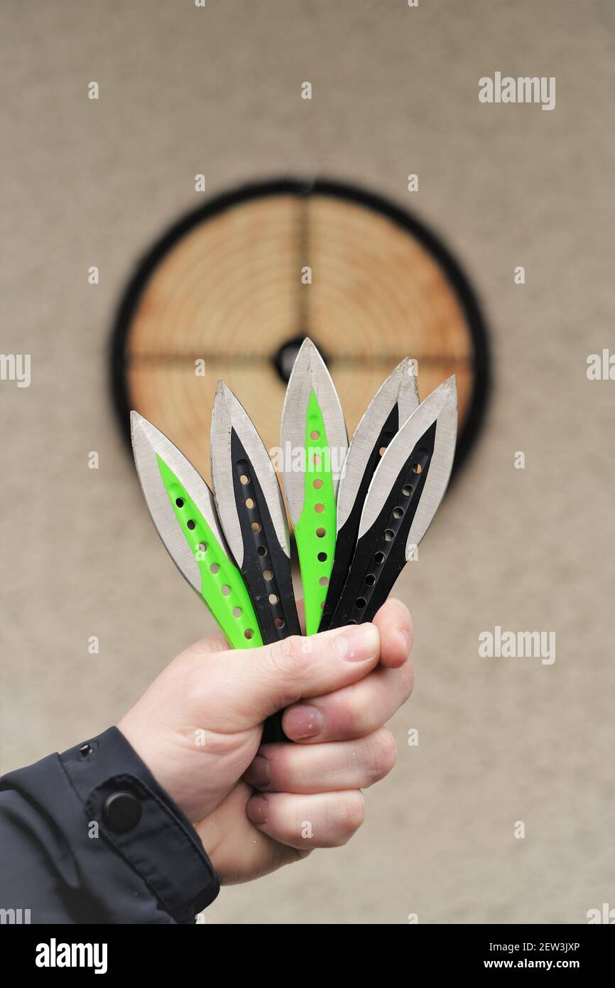 Throwing knives. Sport and hobby . Throwing knives in a man's hand