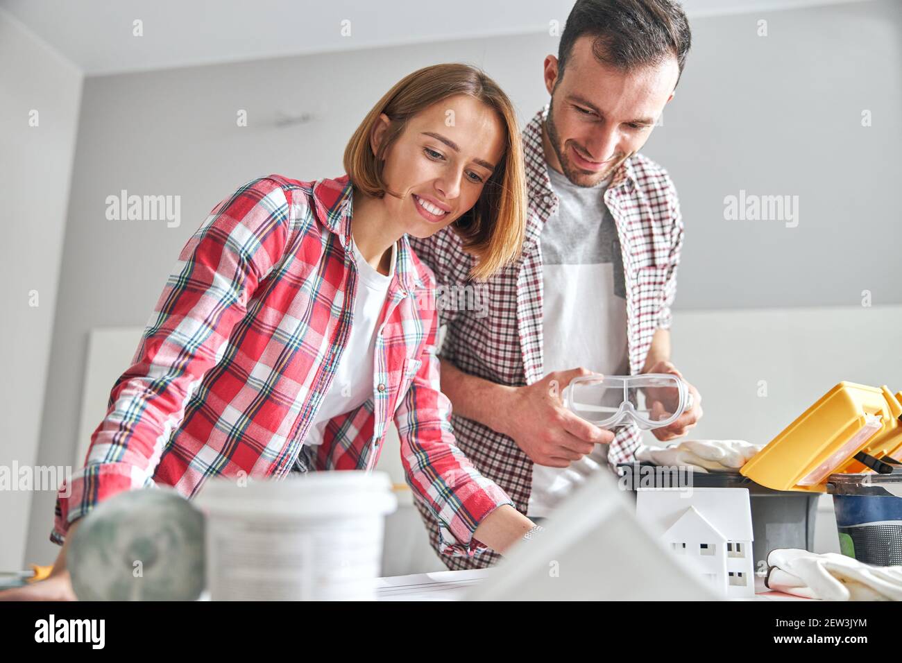 Two young Caucasian architects studying a blueprint Stock Photo