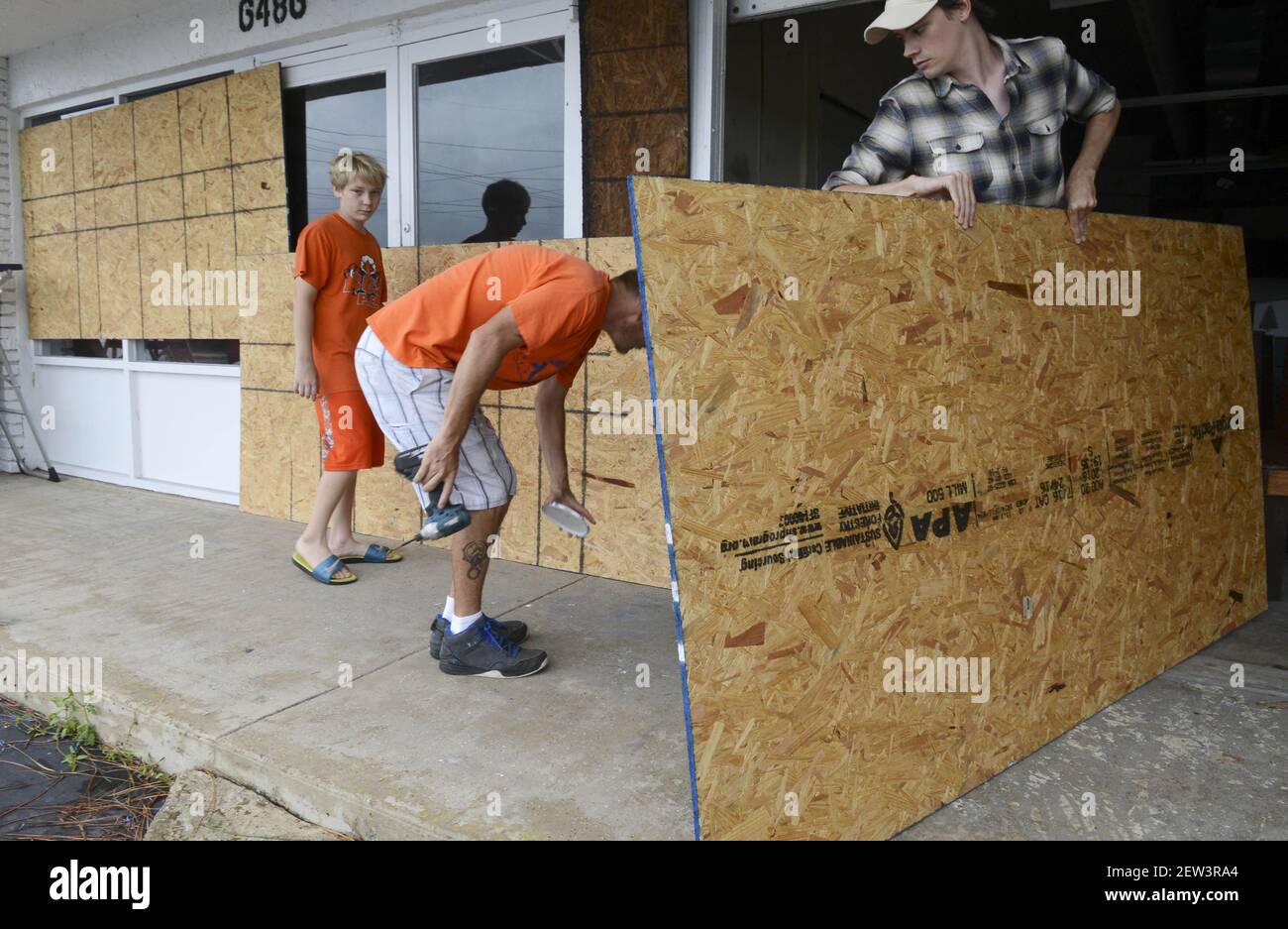 Sep 9, 2017; Melbourne, FL, USA; Ian Hart, Brian Anderson and James Anderson II put up shutters on their business in Melbourne, FL. Mandatory Credit: Craig Bailey/Florida Today via USA TODAY NETWORK Stock Photo