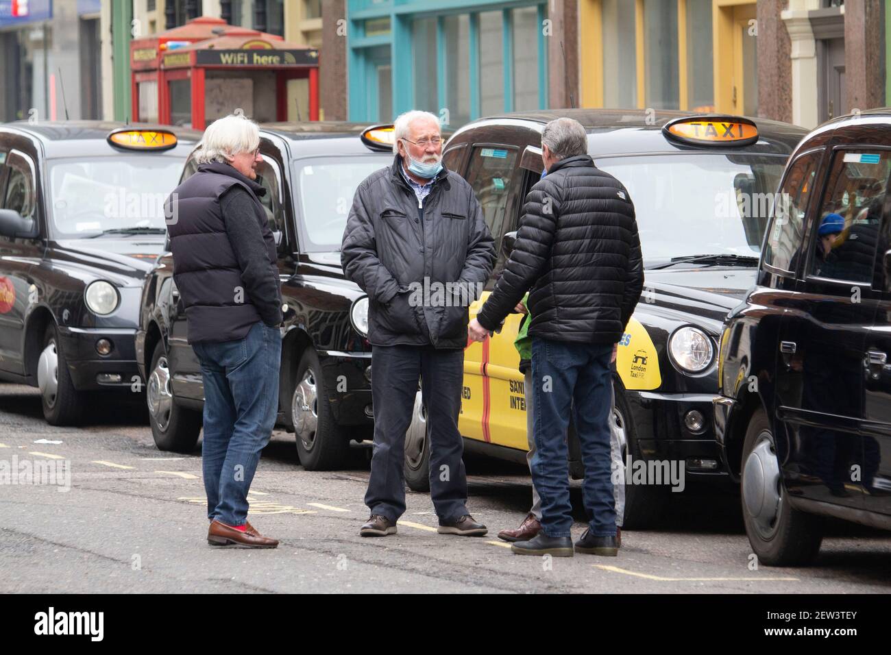 London taxi black cab drivers in packed taxi rank waiting for fares during Coronavirus Covid-19 Pandemic lockdown Stock Photo