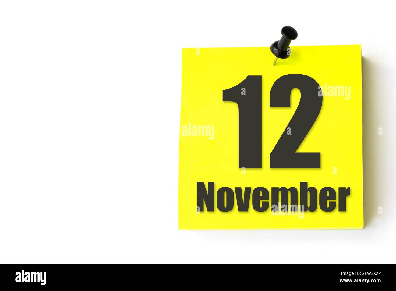 November 12nd. Day 12 of month, Calendar date. White alarm clock on yellow  background with calendar day. Autumn month, day of the year concept. Stock  Photo