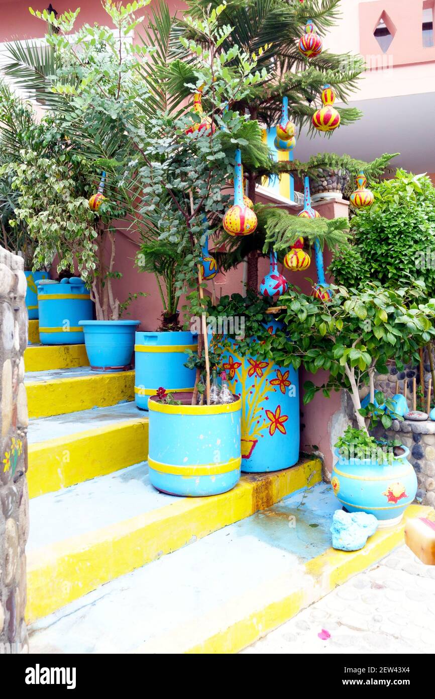 Brightly coloured plant pots and stairs in Kefalos Old Town in Kos, one of the Greek islands Stock Photo